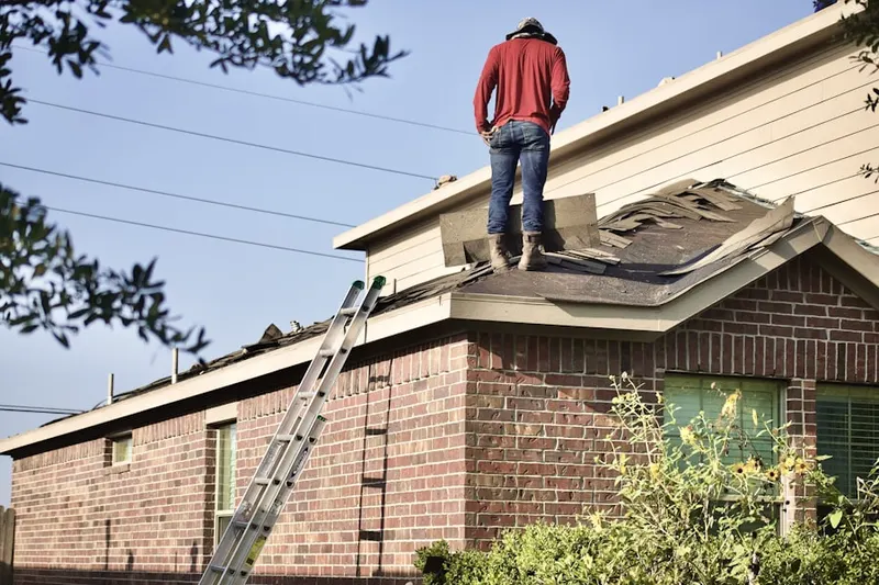 Professional roofer working on a residential roof in Lott